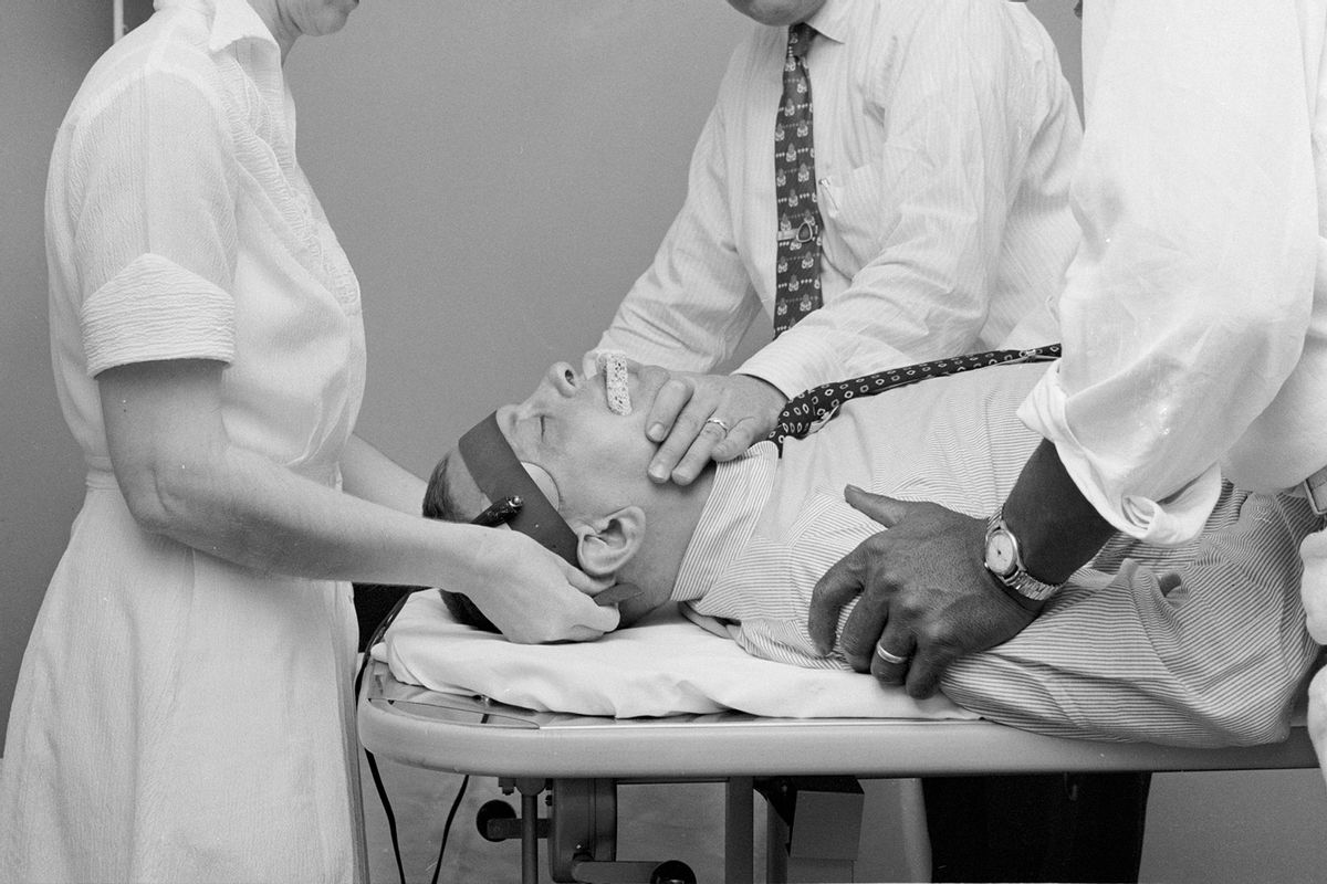 A patient at Hillside mental hospital undergoes electroconvulsive therapy (ECT), whereby an electric current is passed through the head. Developed in the 1930's, this controversial method is used in the treatment of severe depression in adults. (Carl Purcell/Three Lions/Getty Images)