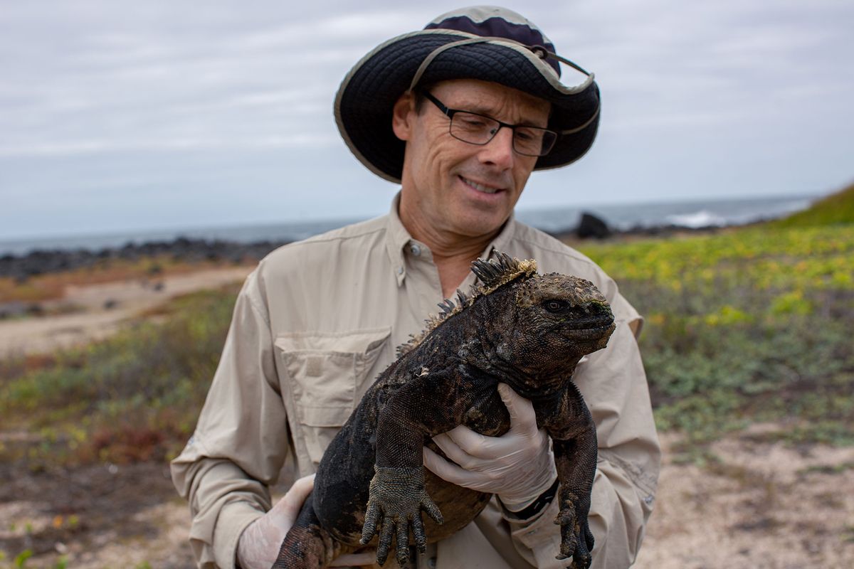 Marine biologist Greg Lewbart holds a marine iguana. (Courtesy of Passion Planet Ltd.)