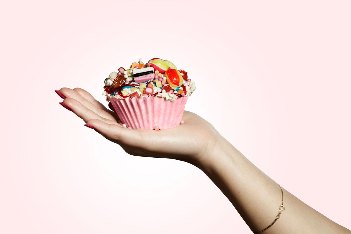 Hand holding a cupcake (Getty Images/Paper Boat Creative)