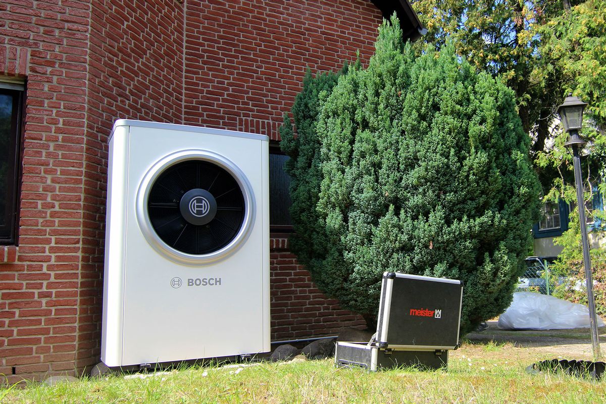 A Bosch heat pump that has just been installed and a workman's case can be seen in front of a semi-detached house. (Doreen Garud/picture alliance via Getty Images)