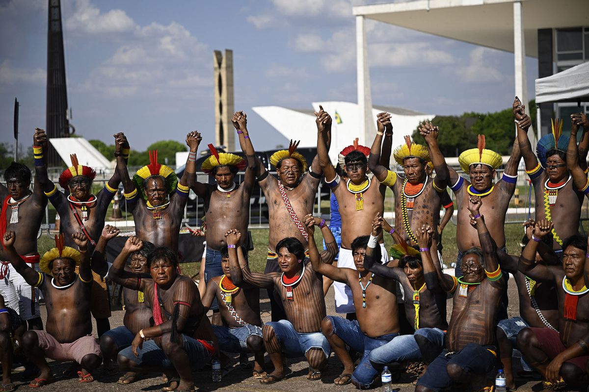 Indigenous people react as they watch a broadcast of the 'Temporal Framework' trial on a screen installed in front of the Supreme Federal Court (STF) in Brasilia, Brazil on September 21, 2023. (Mateus Bonomi/Anadolu Agency via Getty Images)