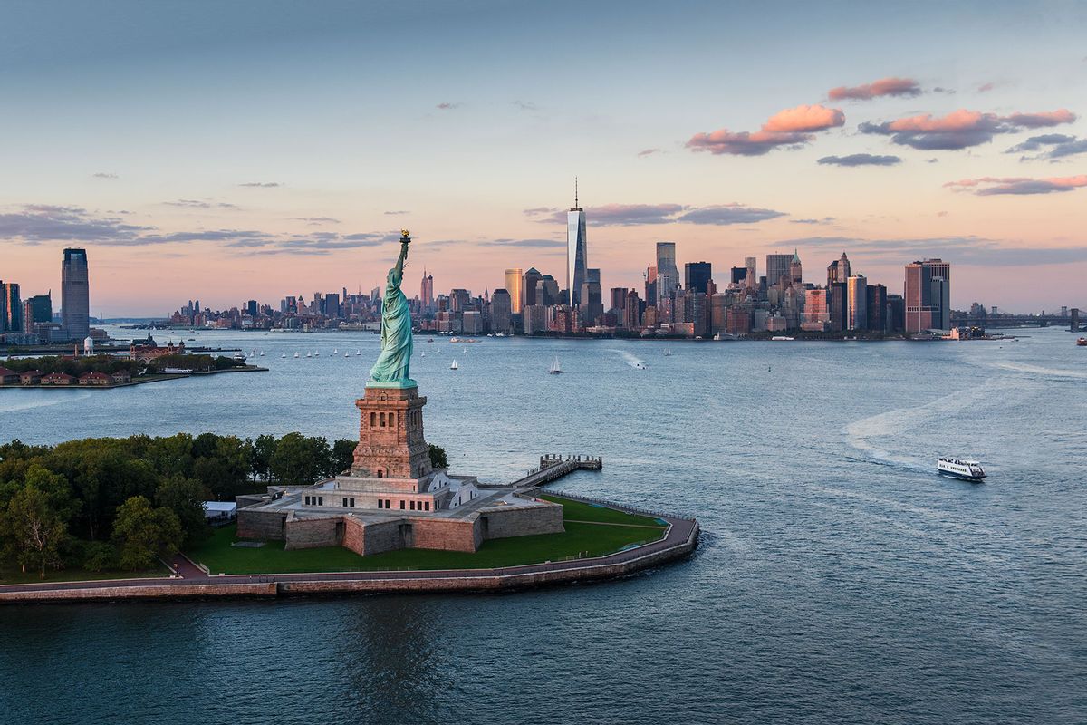 New York City, Aerial view of city with Statue of Liberty at sunset (Getty Images/Tetra Images)