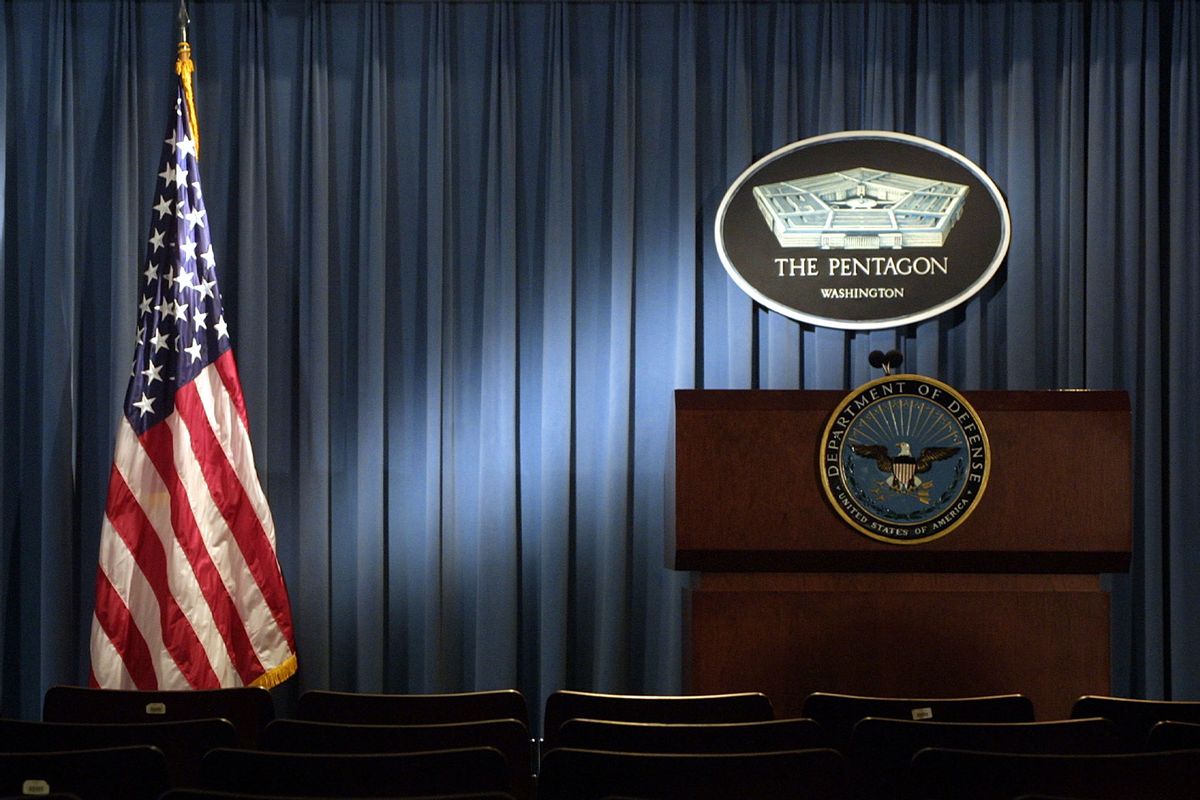 The Pentagon logo and an American flag are lit up in the briefing room of Pentagon in Arlington, VA. (Getty Images/Alex Wong/Getty Images)
