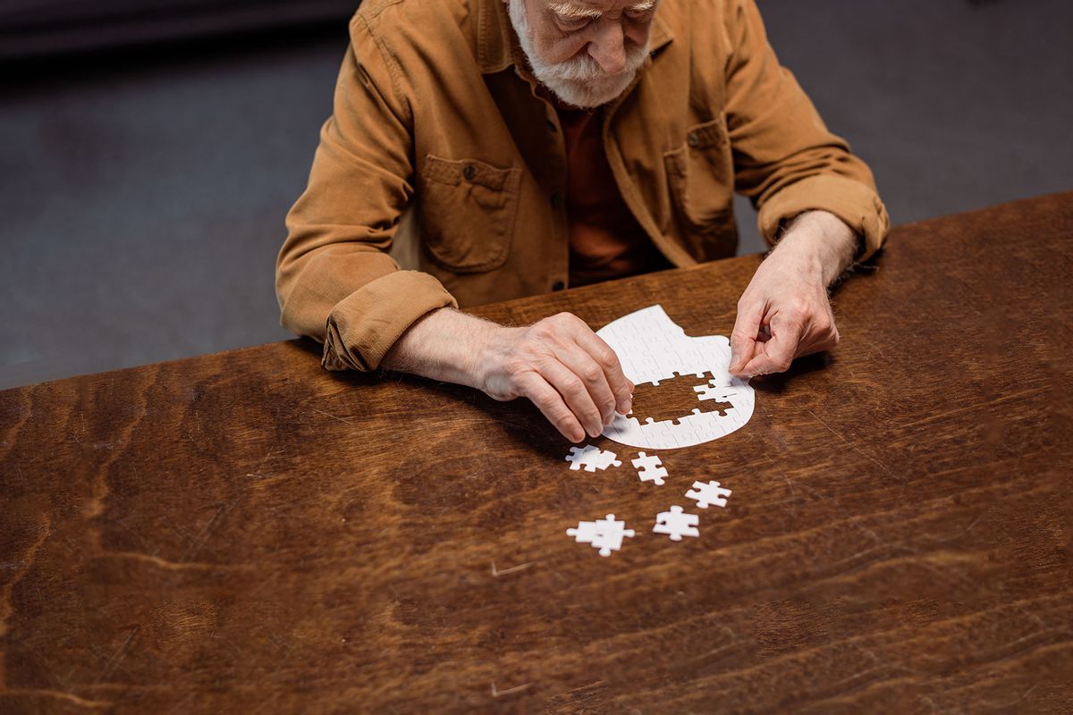 Senior man doing a jigsaw puzzle (Getty Images/LightFieldStudios)