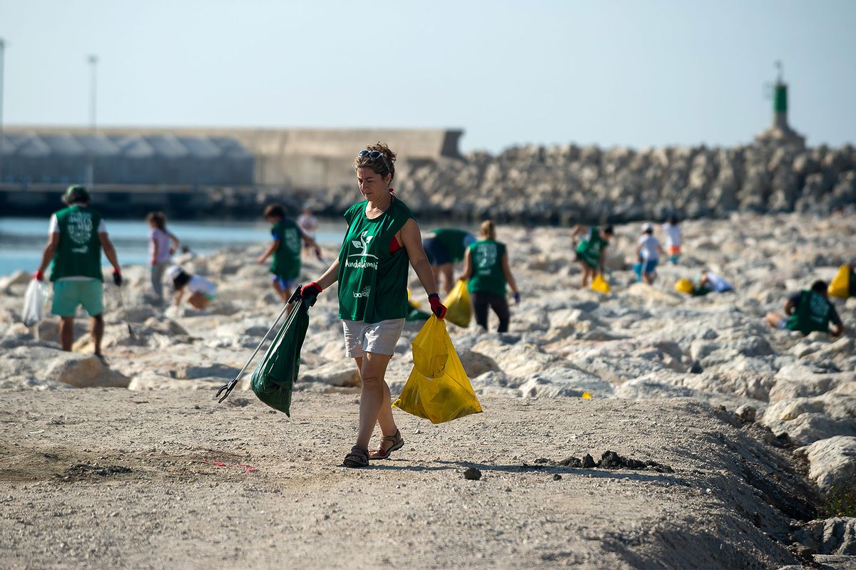 Volunteers are seen collecting waste and plastic during the cleaning of San Andrés Beach ahead of World Environment Day on June 5th. (Jesus Merida/SOPA Images/LightRocket via Getty Images)