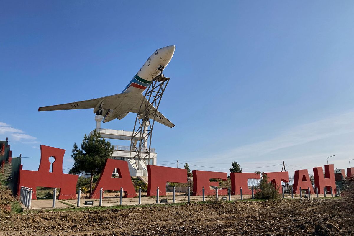 A Tupolev Tu-134B passenger plane is seen on the postament next to a sign reading as 'Dagestan' outside the airport in Makhachkala on October 30, 2023. Russian police on October 30, 2023 said they had arrested 60 people suspected of storming an airport in the Muslim-majority Caucasus republic of Dagestan, seeking to attack Jewish passengers coming from Israel. (STRINGER/AFP via Getty Images)