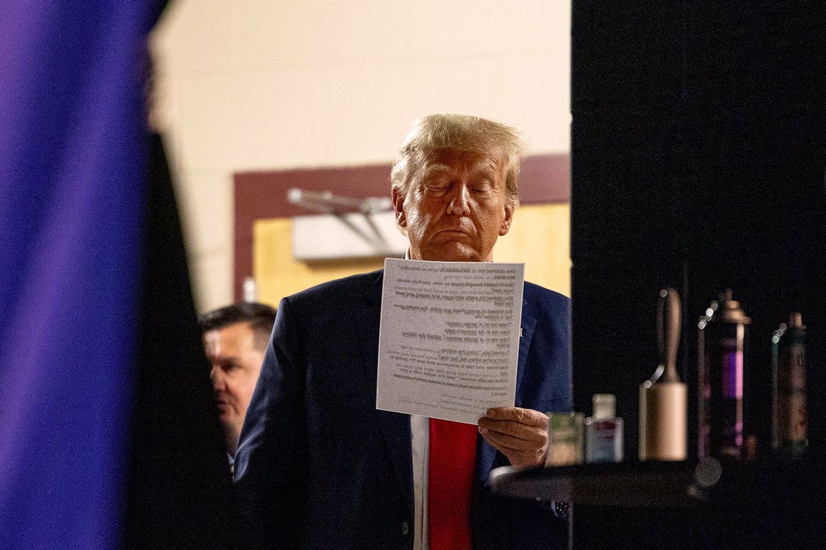 Republican presidential candidate former President Donald Trump reads a document backstage before taking the stage on October 9, 2023 in Wolfeboro, New Hampshire (Scott Eisen/Getty Images)