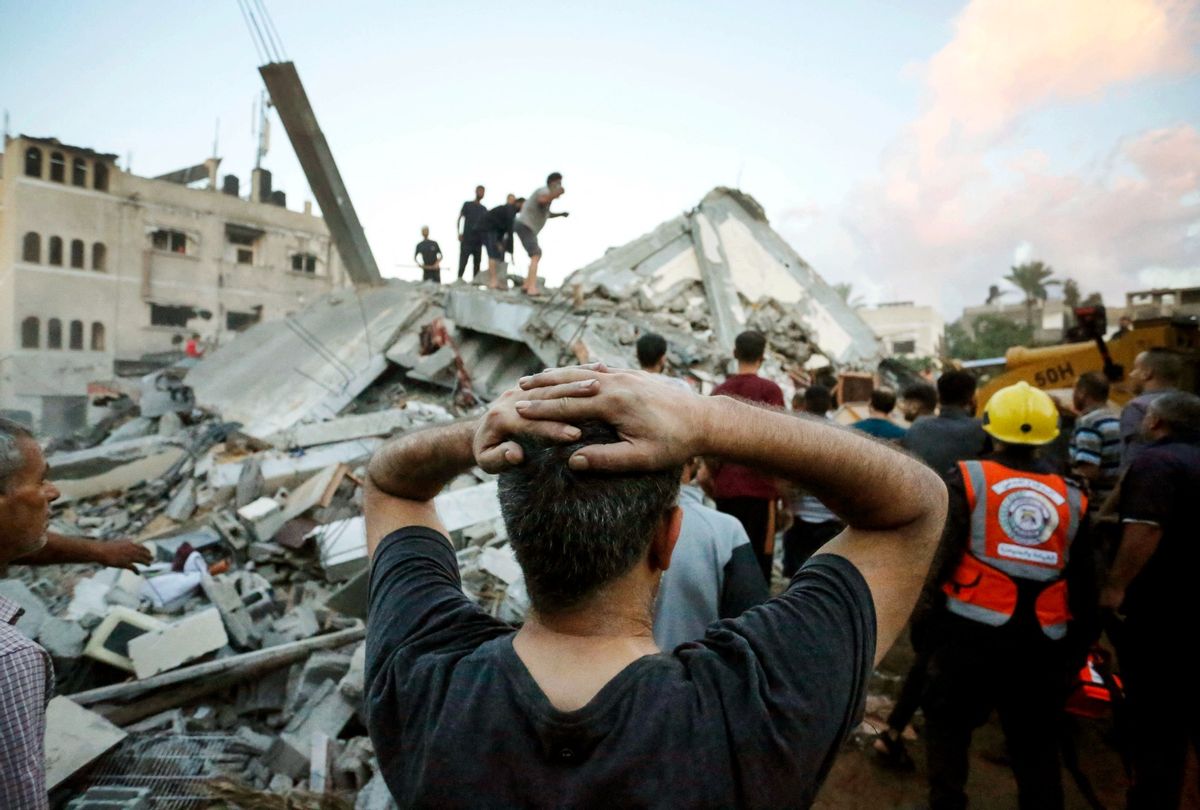 A man reacts as he watches recuers and civilians remove the rubble of a home destroyed following an Israeli attack on the town of Deir Al-Balah, in the central Gaza Strip, on October 15, 2023, amid the ongoing battles between Israel and the Palestinian Islamist group Hamas. (MOHAMMED FAEQ/AFP via Getty Images)