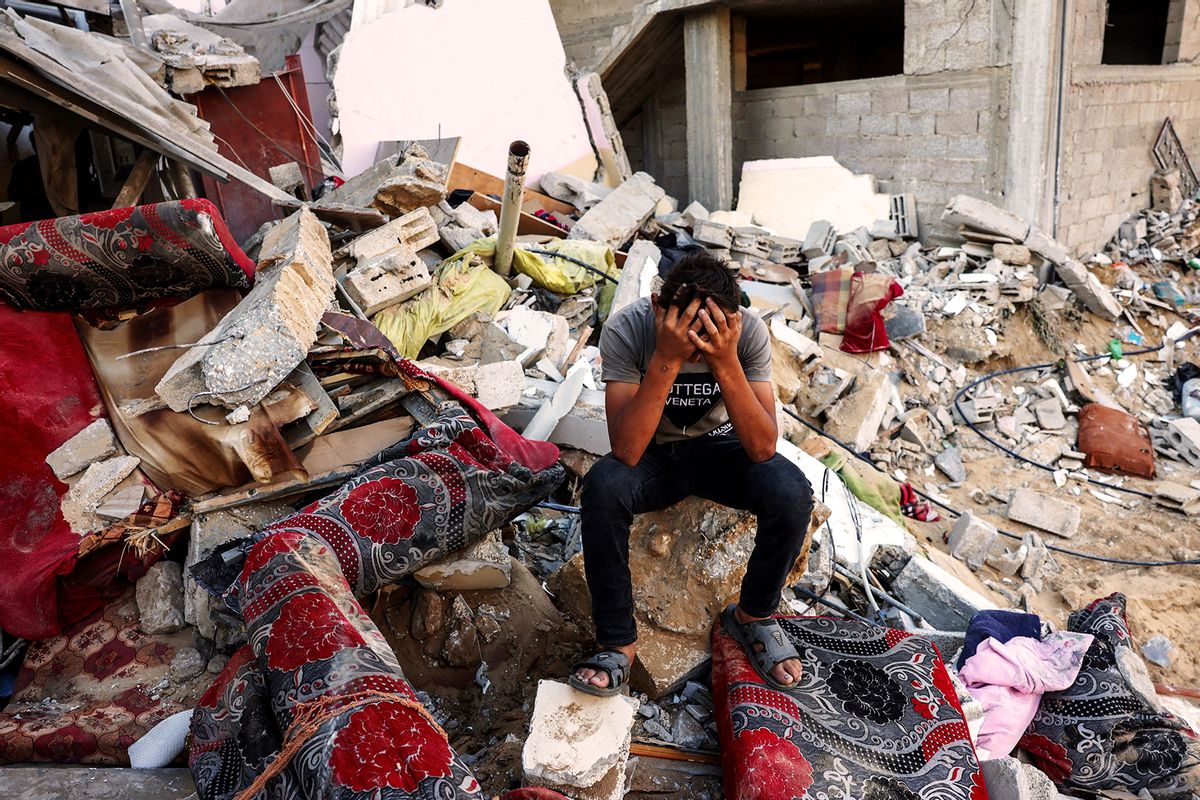 A Palestinian youth reacts as he sits on the rubble of a destroyed home following an Israeli military strike on the Rafah refugee camp, in the southern of Gaza Strip on Octobers 15, 2023, amid the ongoing battles between Israel and the Palestinian Islamist group Hamas. (MOHAMMED ABED/AFP via Getty Images)