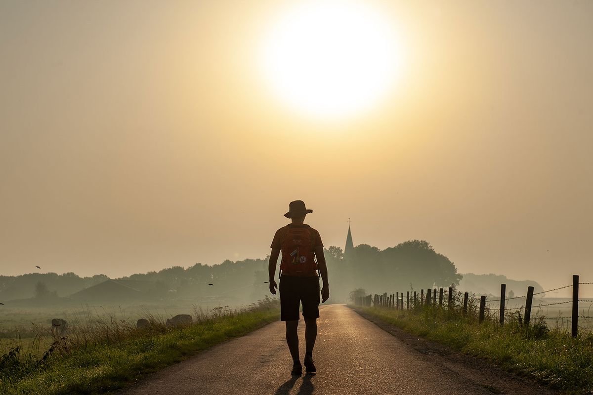 A man is seen walking on a foggy warm sunrise during a new heat record in The Netherlands. In Nijmegen, on September 10th, 2023. (Romy Arroyo Fernandez/NurPhoto via Getty Images)