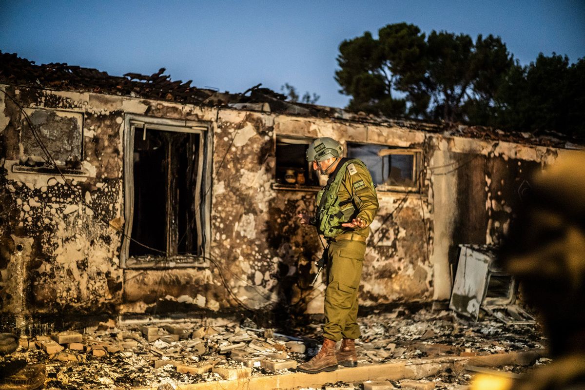 An Israeli soldier inspects a destroyed house in Kibbutz Be'eri as Israeli army regained control. (Ilia Yefimovich/picture alliance via Getty Images)