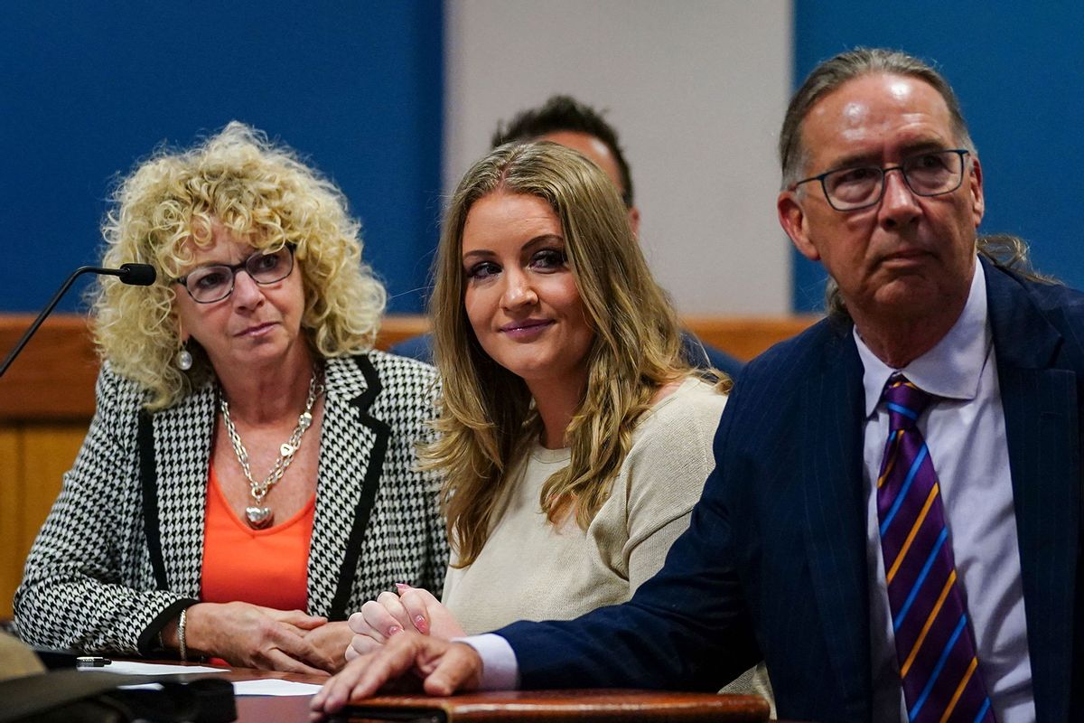 Jenna Ellis reacts with her lawyers after reading a statement pleading guilty to one felony count of aiding and abetting false statements and writings inside Fulton Superior Court Judge Scott McAfee's Fulton County Courtroom in Atlanta, Georgia, on October 24, 2023. (JOHN BAZEMORE/POOL/AFP via Getty Images)