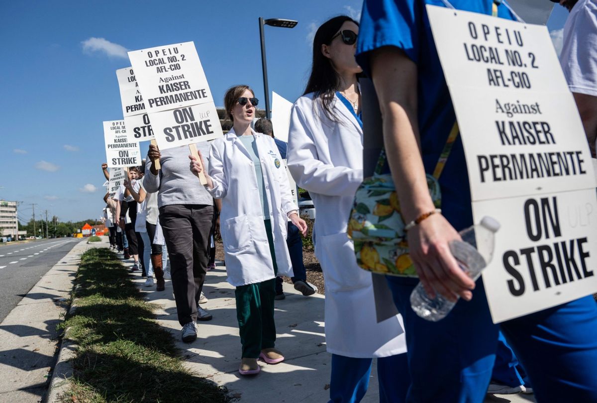 Employees and union representatives with the Office and Professional Employees International Union (OPEIU) local 2, march in a picket line as they strike outside of the Kaiser Permanente Springfield medical offices in Springfield, Virginia on October 4, 2023. (ANDREW CABALLERO-REYNOLDS/AFP via Getty Images)