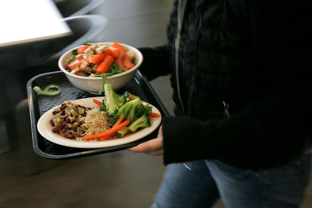 A student at the University of California, Berkeley carries a tray with organic vegetables at UC Berkeley's Crossroads dining commons. (Justin Sullivan/Getty Images)