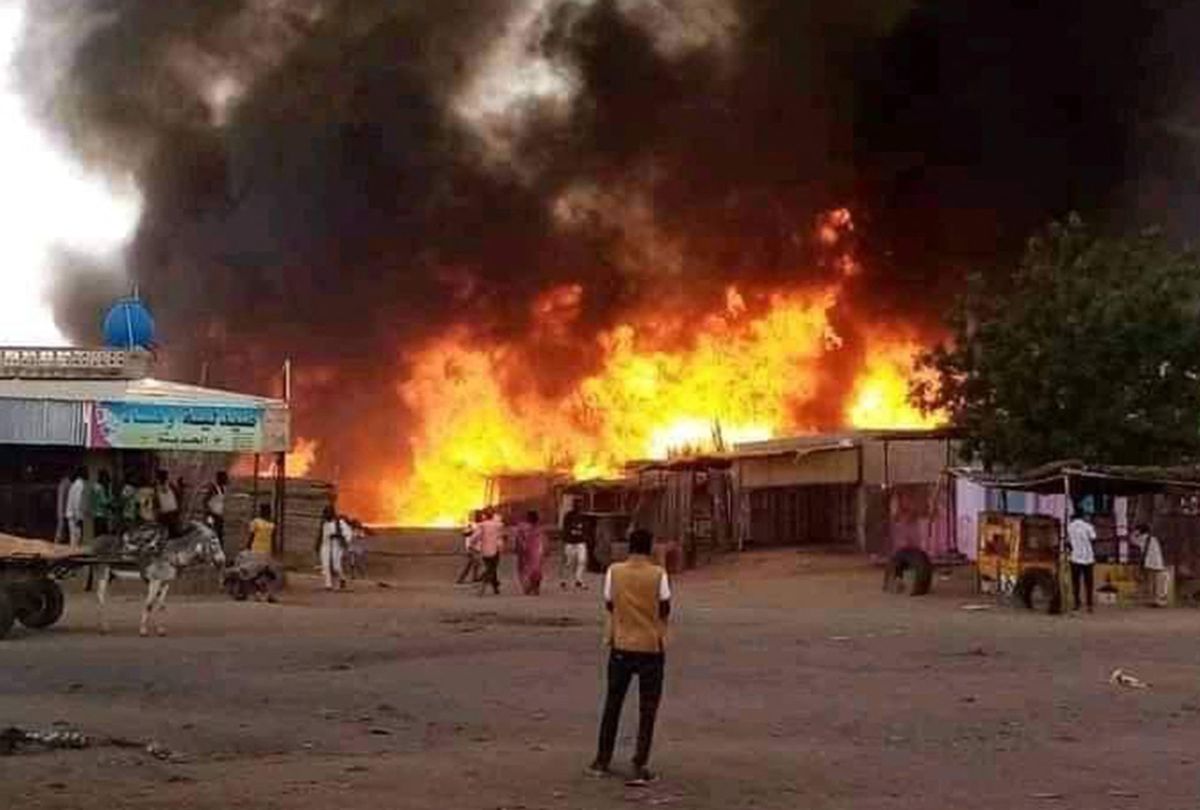 A man stands by as a fire rages in a livestock market area in al-Fasher, the capital of Sudan's North Darfur state, on September 1, 2023, in the aftermath of bombardment by the paramilitary Rapid Support Forces (RSF). (AFP via Getty Images)