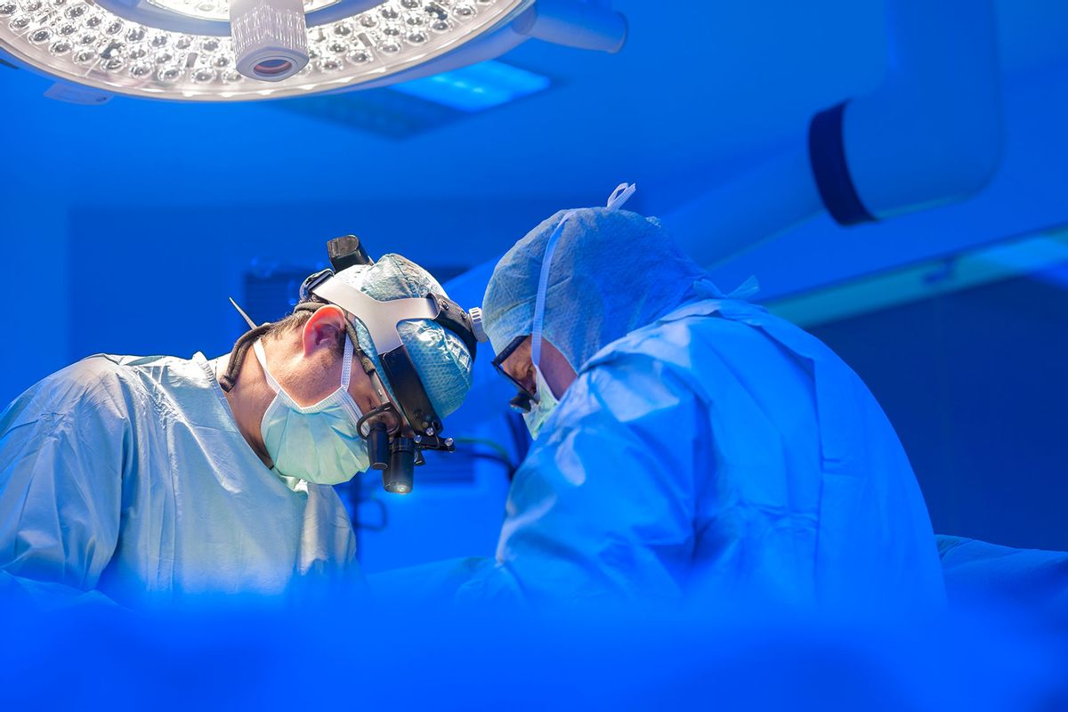 Surgeons performing open heart surgery (Getty Images/Thierry Dosogne)