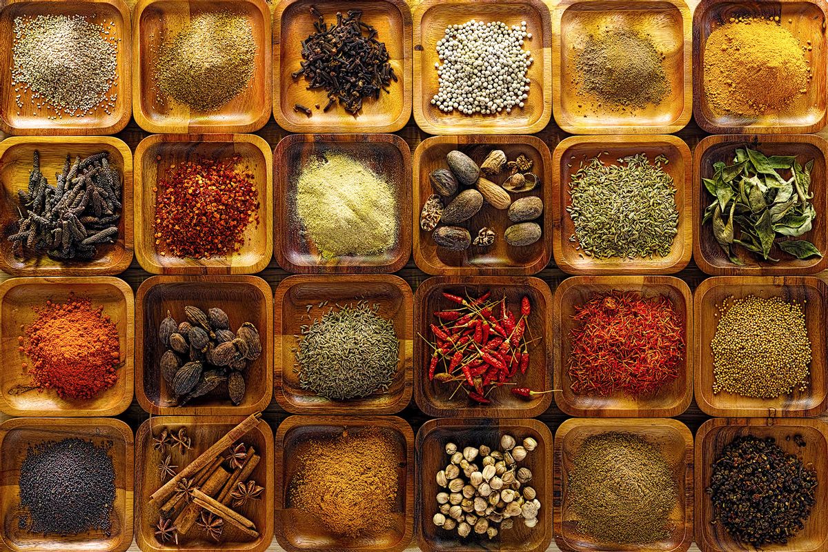 A large selection of commonly used Indian cooking spices in wooden trays on an old table. (Getty Images/enviromantic)