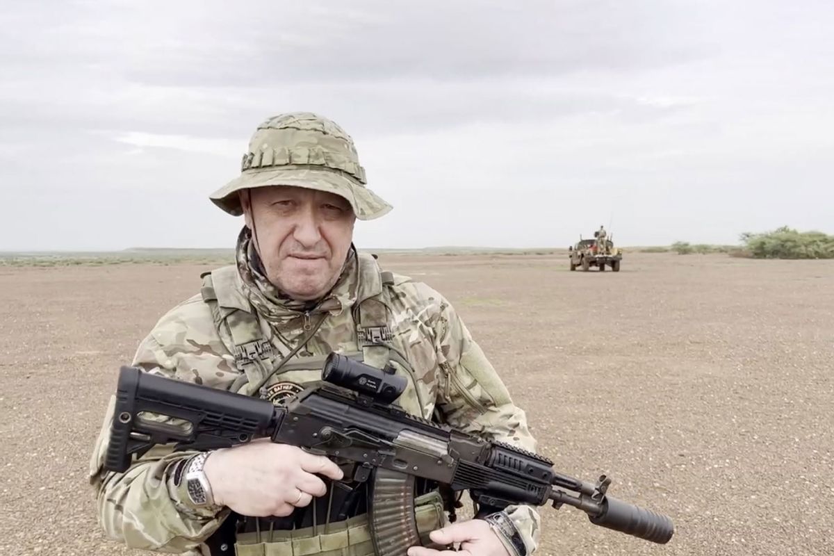 A screen grab captured from a video shared online shows Yevgeny Prigozhin, the founder of the Russian private security company Wagner, holding a rifle in a desert area while wearing camouflage in a video for the first time after his rebellion against the Russian administration in an unspecified location in Africa on August 21, 2023. (Wagner Account/Anadolu Agency via Getty Images)