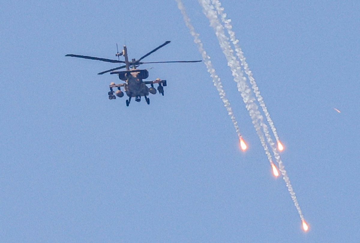 An Israeli military AH-64 Apache attack helicopter fires flares while flying over Ashkelon in southern Israel on August 6, 2022. (JACK GUEZ/AFP via Getty Images)