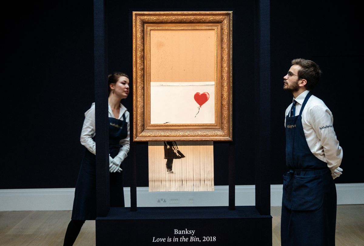Sotheby's employees view "Love is in the Bin" by British artist Banksy at Sotheby's auction house on October 12, 2018 in London, United Kingdom (Jack Taylor/Getty Images)