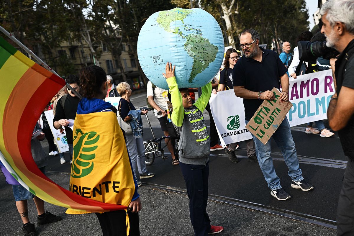 A child holds a globe balloon during a demonstration as part of the Fridays for Future movement for climate change in Turin on October 6, 2023. (MARCO BERTORELLO/AFP via Getty Images)