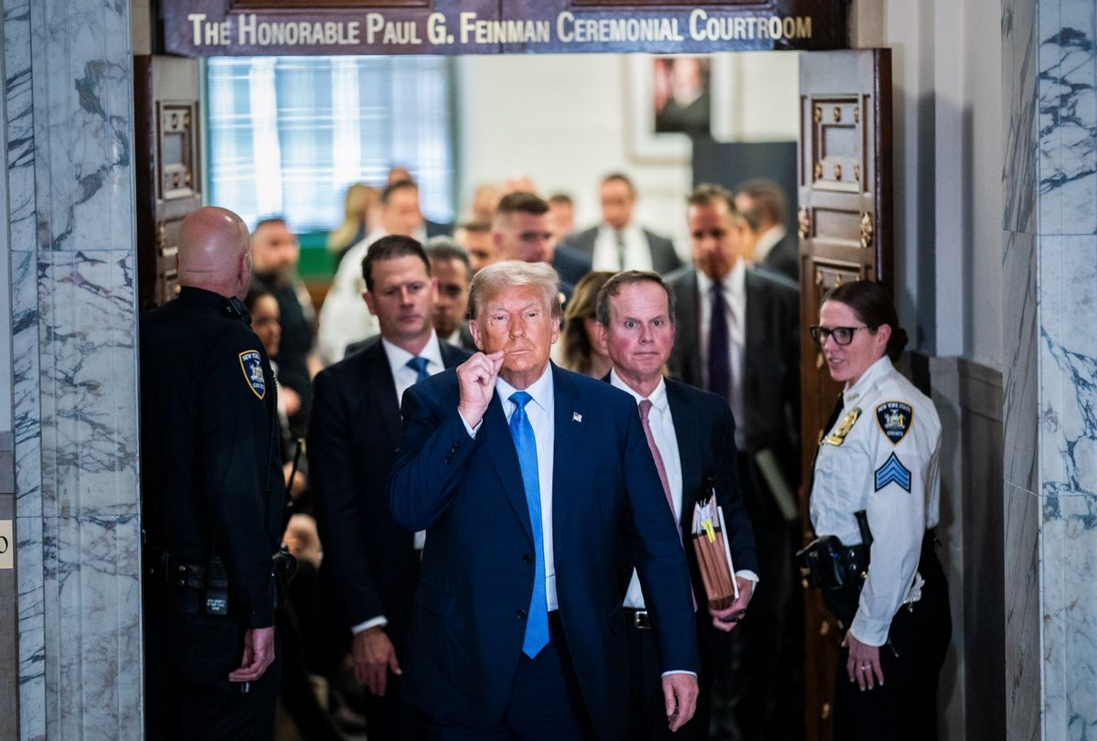 Former President Donald Trump gestures a zipped lip as he walks out of the courtroom during a break before testifying in his civil fraud case at the State Supreme Court of New York on Monday, Nov. 06, 2023.  (Jabin Botsford/The Washington Post via Getty Images)