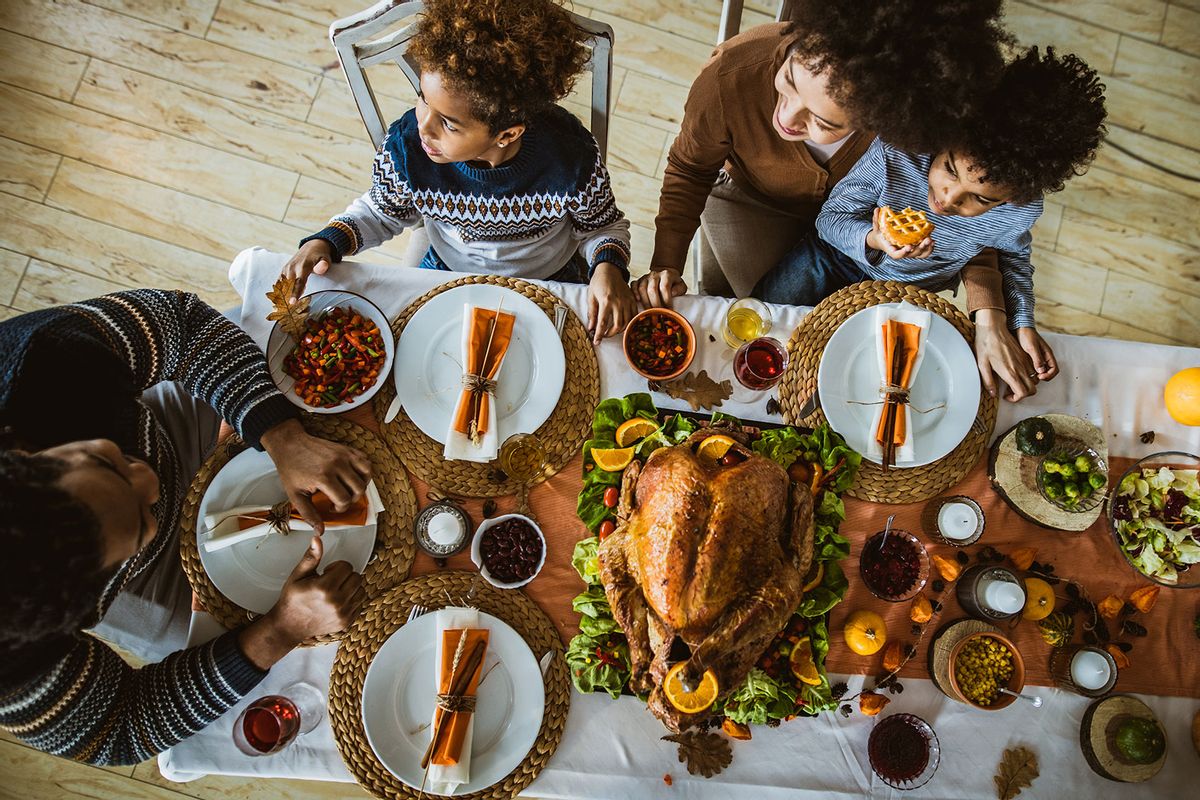 Above view of black family during Thanksgiving meal at dining table (Getty Images/skynesher)