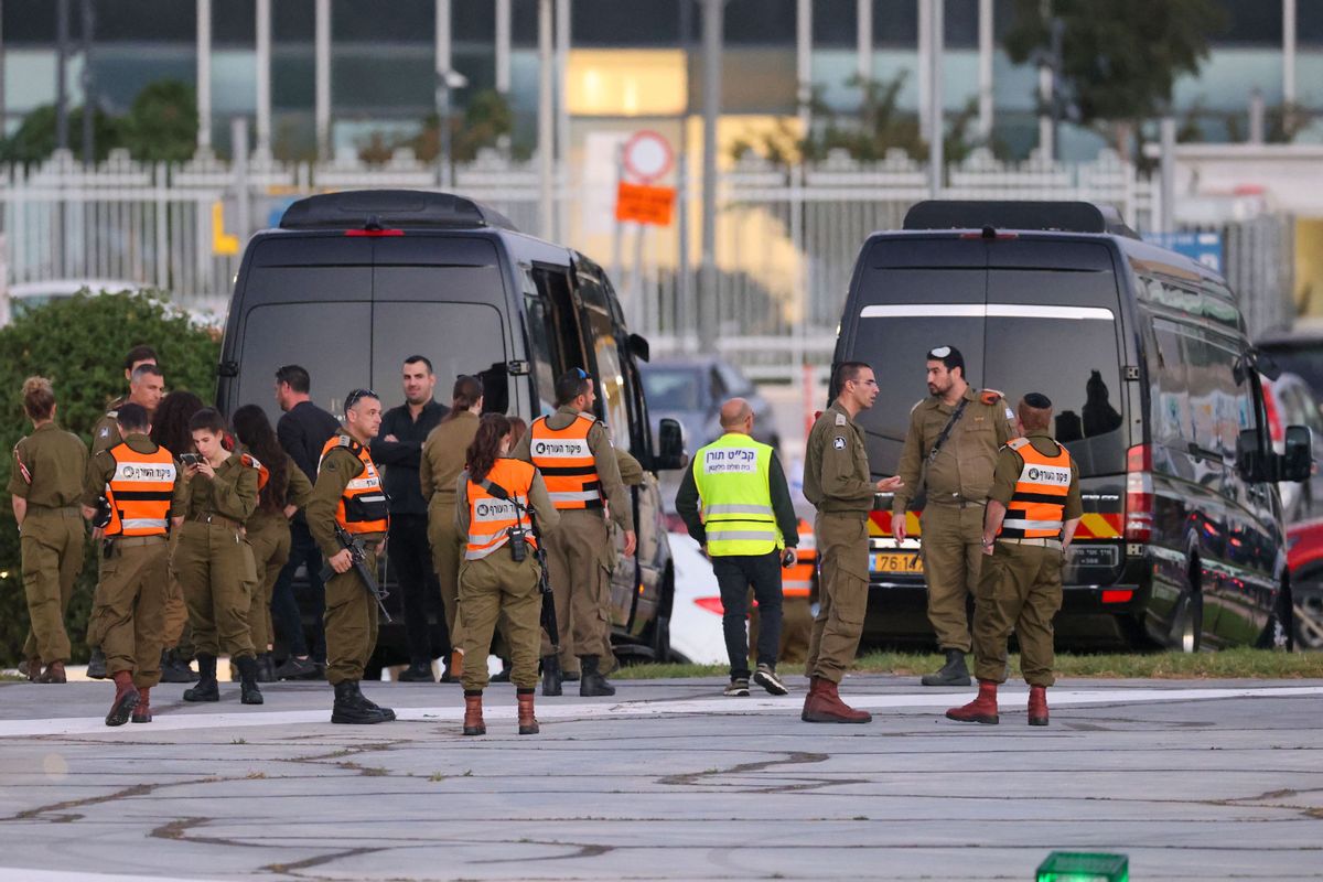Israeli security forces stand next to buses waiting at the helipad of Tel Aviv's Schneider medical centre on November 24, 2023, amid preparations for the release of Israeli hostages held by Hamas in Gaza in exchange for Palestinian prisoners later in the day. After 48 days of gunfire and bombardment that claimed thousands of lives, a four-day truce in the Israel-Hamas war began on November 24 with 50 hostages set to be released in exchange for 150 Palestinian prisoners.  ((Photo by FADEL SENNA / AFP) (Photo by FADEL SENNA/AFP via Getty Images))