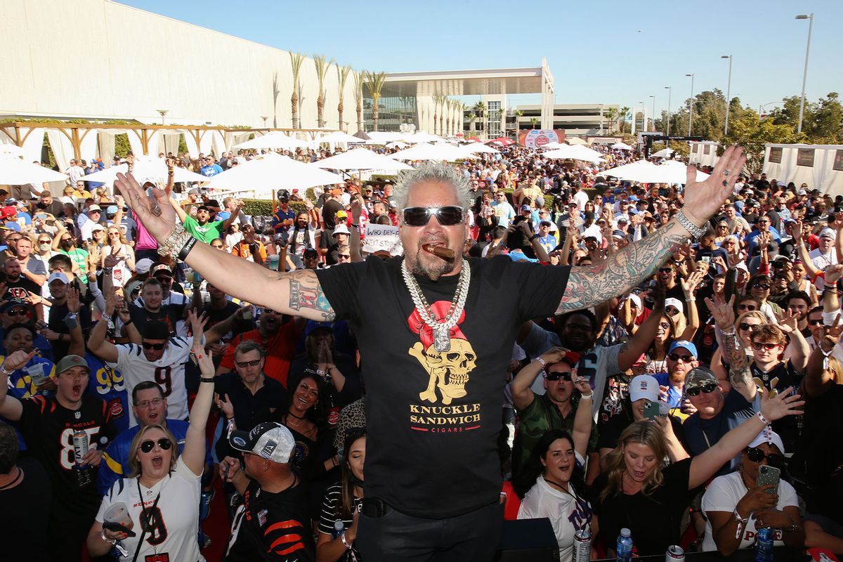Guy Fieri poses with fans onstage during the Players Tailgate by Bullseye Event Group on February 13, 2022 in Los Angeles, California. (Jesse Grant/Getty Images for Bullseye Event Group)
