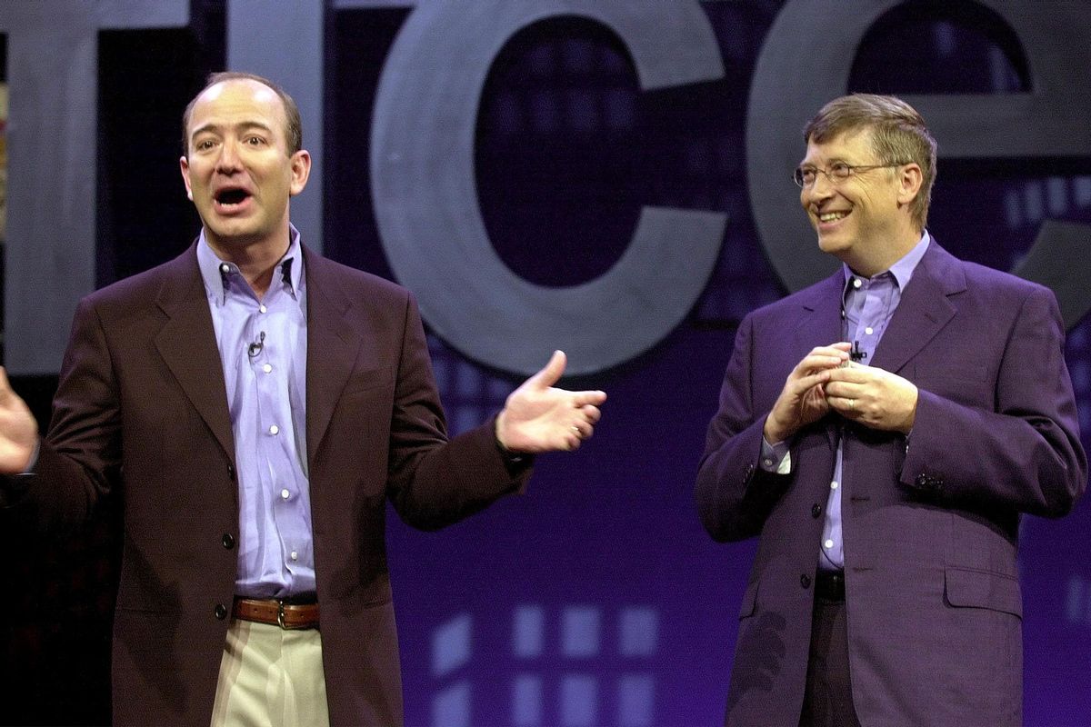 Amazon.com CEO Jeff Bezos (L) tells a joke with Microsoft CEO Bill Gates (R) at the Office XP launch, 31 May, 2001, in New York. (STAN HONDA/AFP via Getty Images)