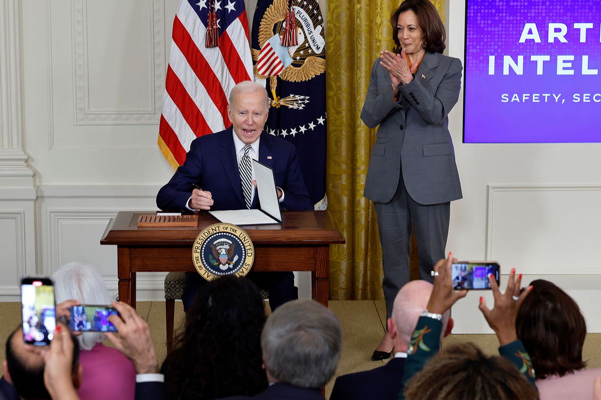 U.S. Vice President Kamala Harris (R) looks on as President Joe Biden signs a new executive order guiding his administration's approach to artificial intelligence during an event in the East Room of the White House on October 30, 2023 in Washington, DC. (Chip Somodevilla/Getty Images)