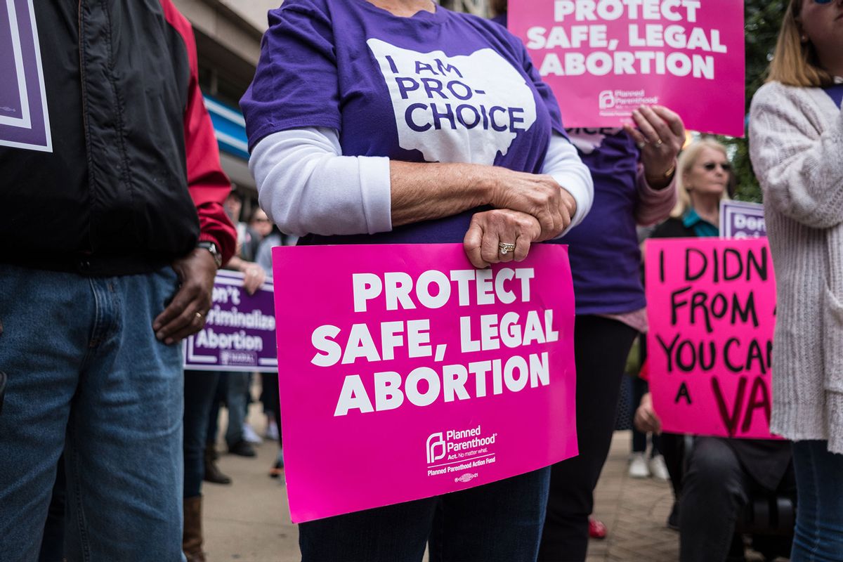 An activist seen holding a placard that says protect safe, legal abortion during the protest. (Megan Jelinger/SOPA Images/LightRocket via Getty Images)