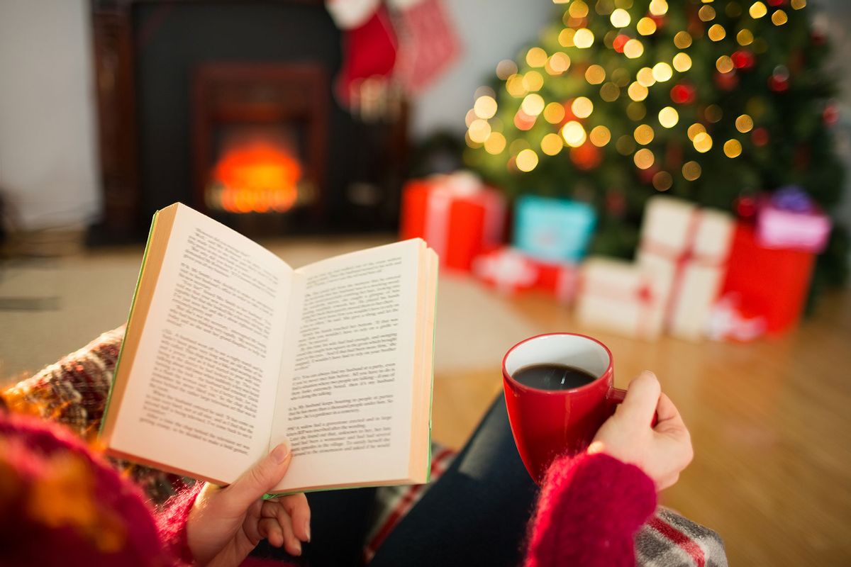 Reading a book and drinking coffee at Christmas (Getty Images/Wavebreakmedia)