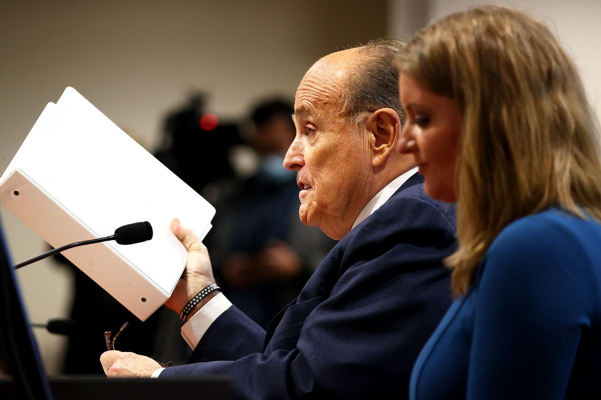 U.S. President Donald Trump's personal attorney Rudy Giuliani speaks as Jenna Ellis, a member of the president's legal team looks on, at an appearance before the Michigan House Oversight Committee on December 2, 2020 in Lansing, Michigan. (Rey Del Rio/Getty Images)