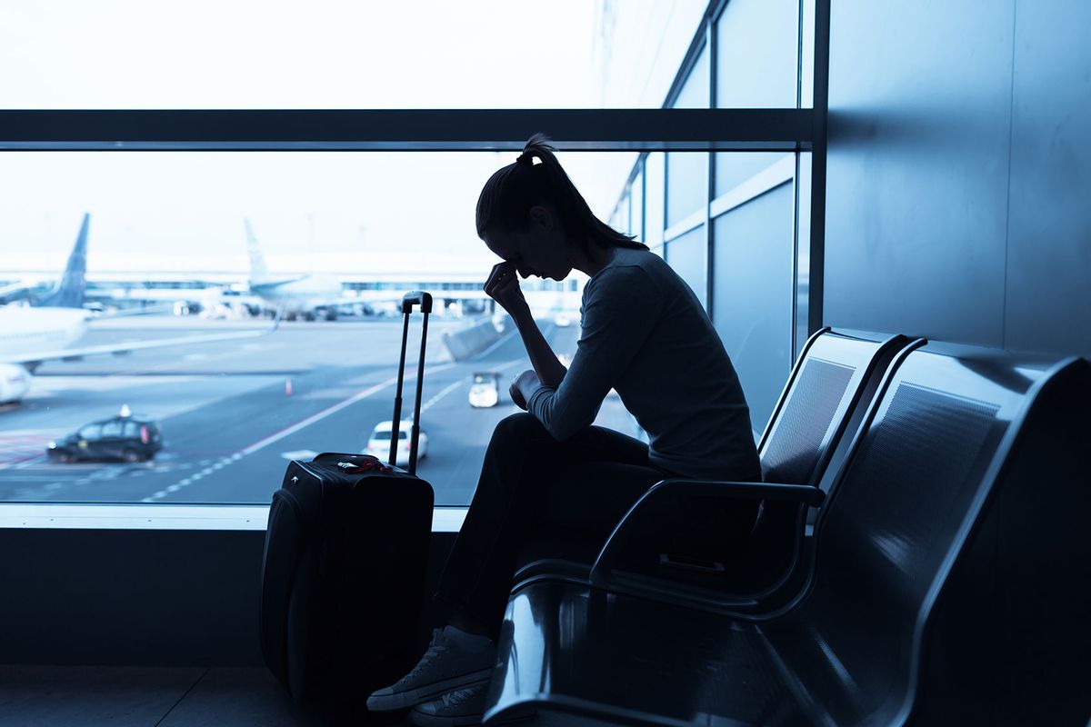 Stressed woman in the airport (Getty Images/kieferpix)