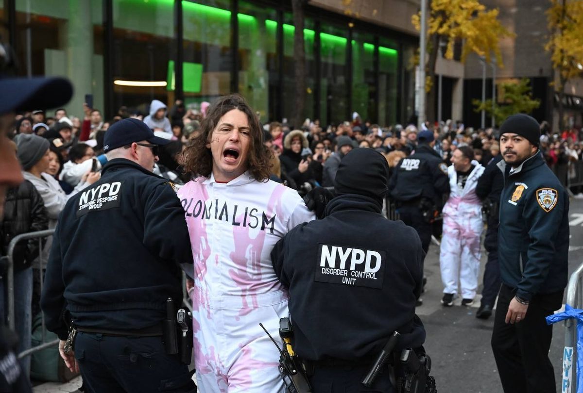 New York Police Department (NYPD) members intervene and take two protesters into custody, who entered the parade, during the traditional Thanksgiving Day parade in New York, United States on November 23, 2023 (Fatih Aktas/Anadolu via Getty Images)