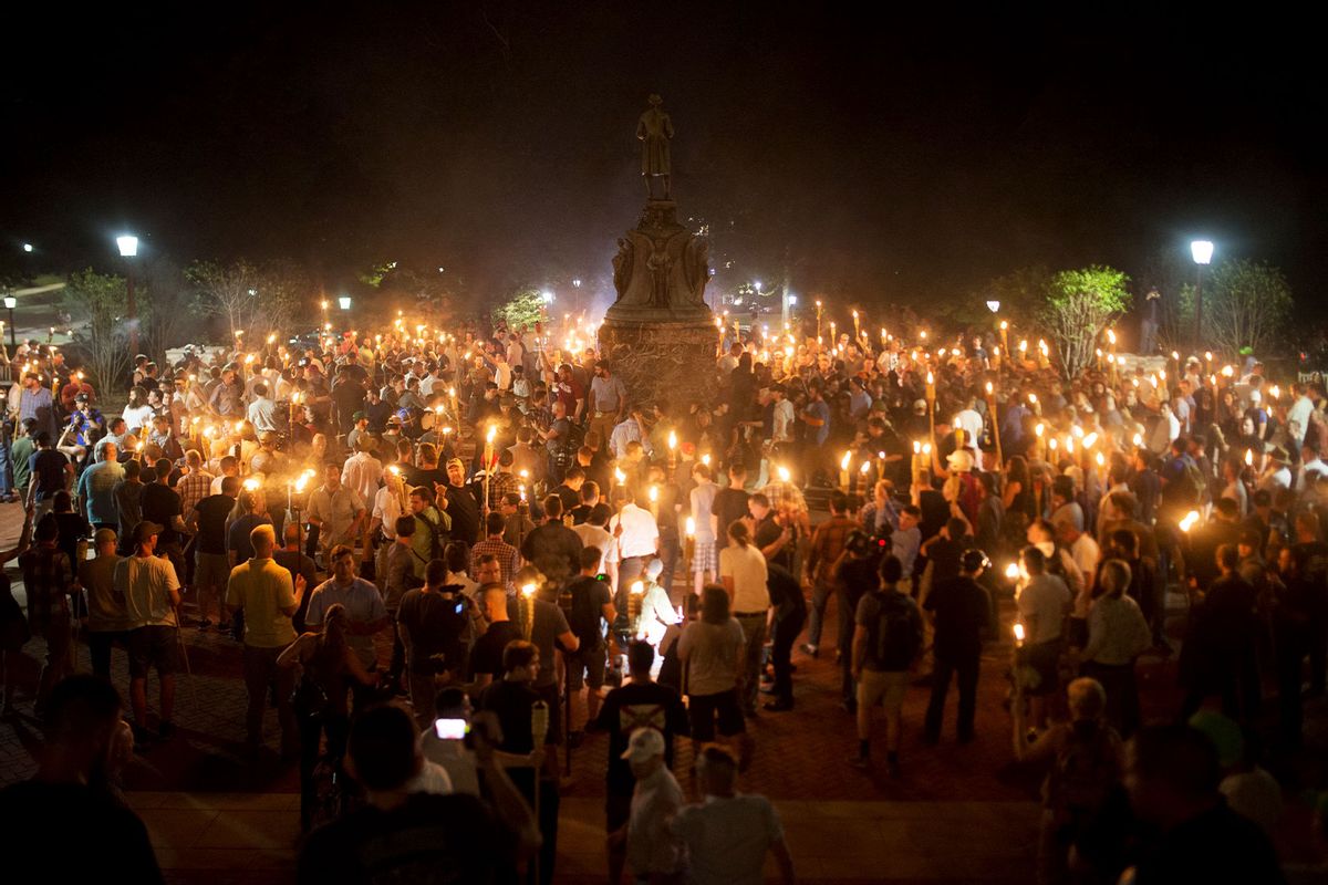 Neo Nazis, Alt-Right, and White Supremacists encircle counter protestors at the base of a statue of Thomas Jefferson after marching through the University of Virginia campus with torches in Charlottesville, Va., USA on August 11, 2017. (Zach D Roberts/NurPhoto via Getty Images)