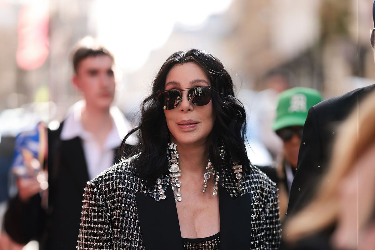 Cher is seen wearing dark shades and big silver diamond earrings, a black top with silver ornaments and matching oversized black jacket with silver ornaments on it before the Valentino Fashion Show during the Womenswear Spring/Summer 2024 as part of Paris Fashion Week on October 01, 2023 in Paris, France. (Jeremy Moeller/Getty Images)