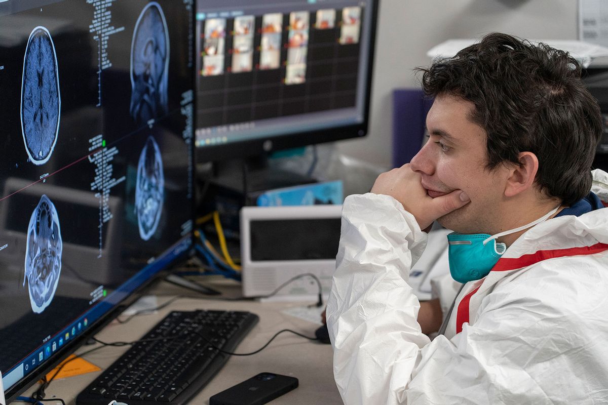 A medical staff member Gabriel Cervera Rodriguez watches a screen which shows a patient's MRI images at nursing station in the COVID-19 intensive care unit (ICU) at the United Memorial Medical Center on December 10, 2020 in Houston, Texas. (Go Nakamura/Getty Images)
