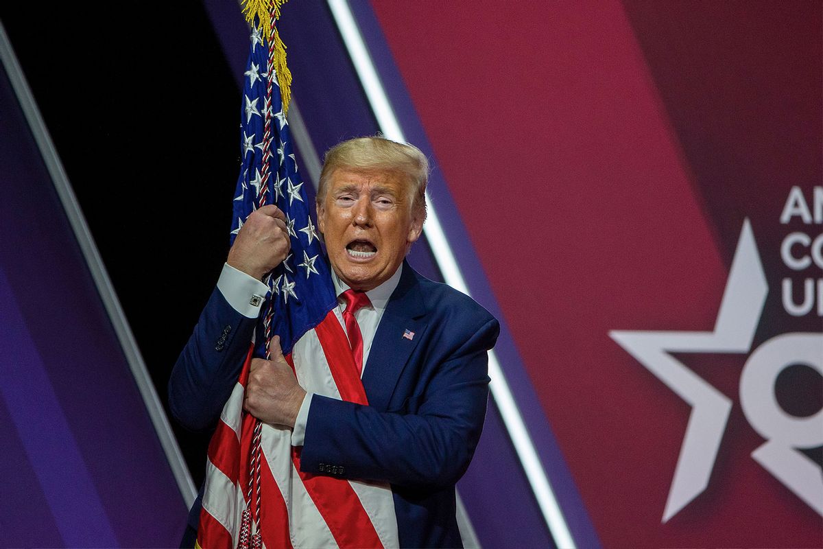 President Donald Trump hugs the flag of the United States of America at the annual Conservative Political Action Conference (CPAC) at Gaylord National Resort & Convention Center February 29, 2020 in National Harbor, Maryland. (Tasos Katopodis/Getty Images)