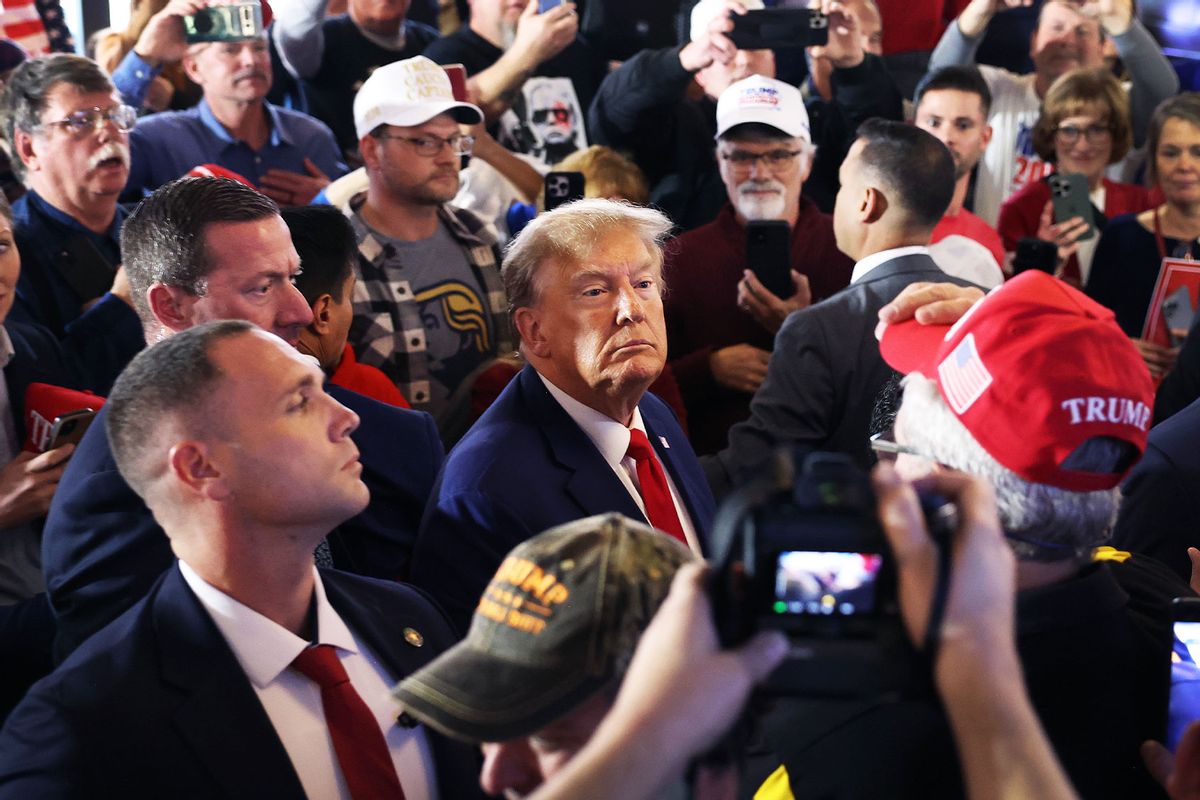 Republican presidential candidate former President Donald Trump greets guests as he arrives at a commit to caucus campaign event at the Whiskey River bar on December 02, 2023 in Ankeny, Iowa. (Scott Olson/Getty Images)
