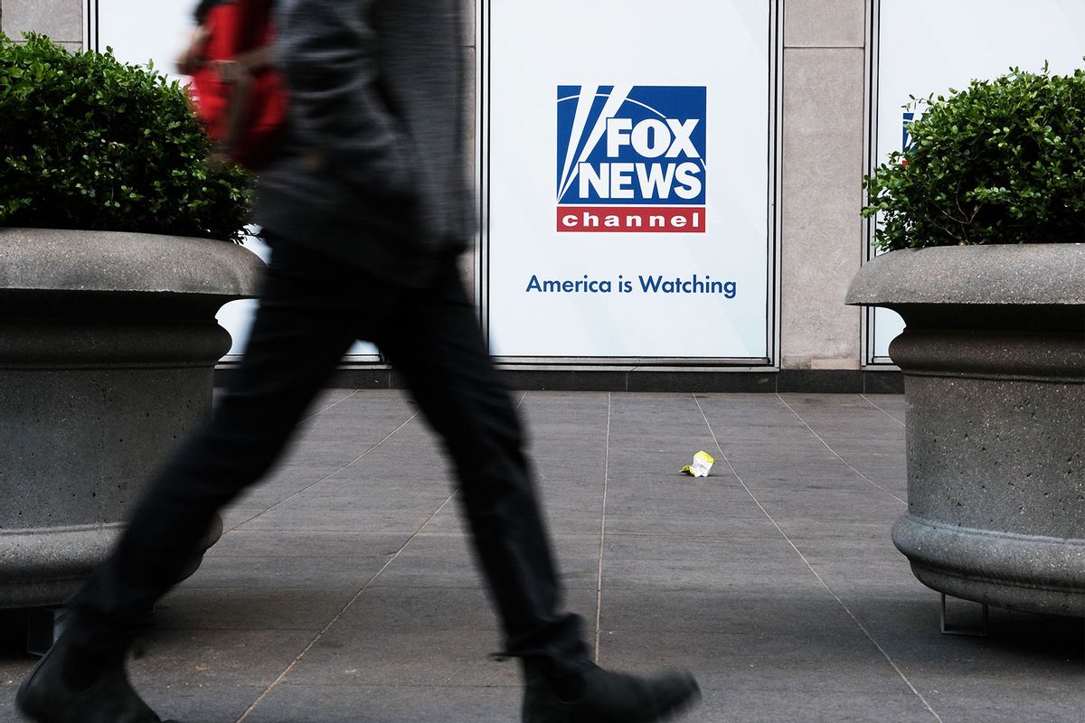 People walk by the News Corporation headquarters, home to Fox News, on April 18, 2023 in New York City. (Spencer Platt/Getty Images)