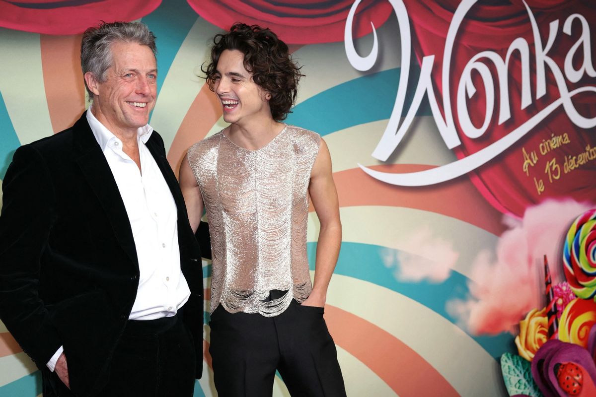 Timothée Chalamet (R) and English actor Hugh Grant pose on the red carpet upon arrival for the Premiere of the film "Wonka" at the UGC Normandie cinema in Paris, on December 1, 2023.  (THOMAS SAMSON/AFP via Getty Images)