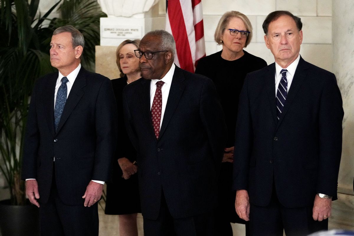 Chief Justice of the United States John Roberts, Justice Clarence Thomas and Justice Samuel Alito attend a private ceremony for retired Supreme Court Justice Sandra Day O'Connor before public repose in the Great Hall at the Supreme Court in Washington, DC, on December 18, 2023. (JACQUELYN MARTIN/POOL/AFP via Getty Images)