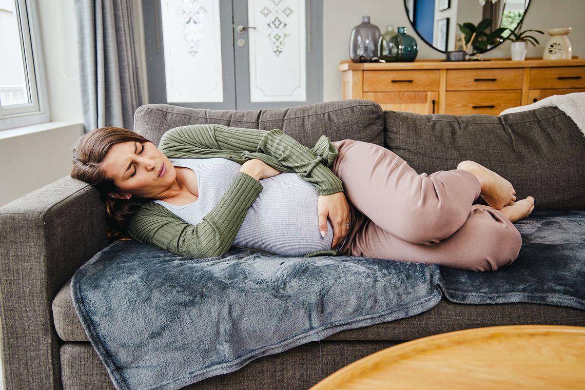 Pregnant woman feeling discomfort (Getty Images/Moyo Studio)