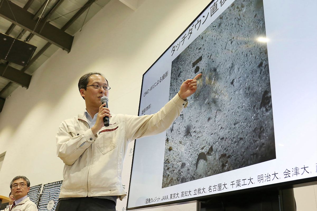 Yuichi Tsuda, project engineer of the Hayabusa2 mission from the Japan Aerospace Exploration Agency (JAXA) points at an image showing the surface of the asteroid Ryugu before touchdown by the Hayabusa2 spacecraft during a press conference in Sagamihara on February 22, 2019. (JIJI PRESS/JIJI PRESS/AFP via Getty Images)