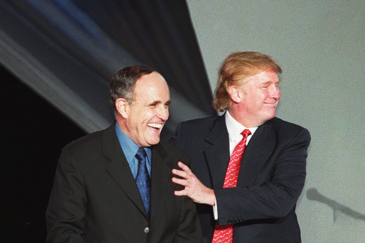 New York City Mayor Rudy Giuliani (L) jokes with Donald Trump (R) as they take a walk down the runway during the NYC2000 fashion show in Times Square 13 September, 1999, in New York City. (MATT CAMPBELL/AFP via Getty Images)