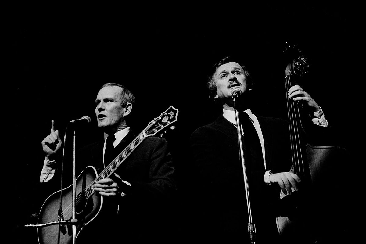 American sibling Folk musicians and comedians Tom (left) and Dick Smothers perform together, as the Smothers Brothers, onstage at the Auditorium Theater, Chicago, Illinois, February 5, 1983. (Paul Natkin/Getty Images)