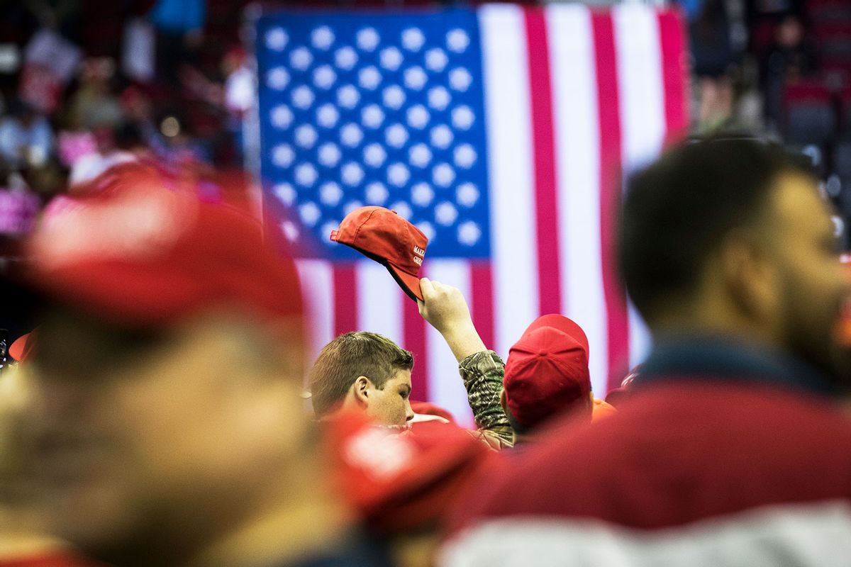 A President Donald Trump supporter waves a MAGA hat at a MAGA Rally in the Toyota Center, Monday, Oct. 22, 2018, in Houston. (Marie D. De Jesus/Houston Chronicle via Getty Images)