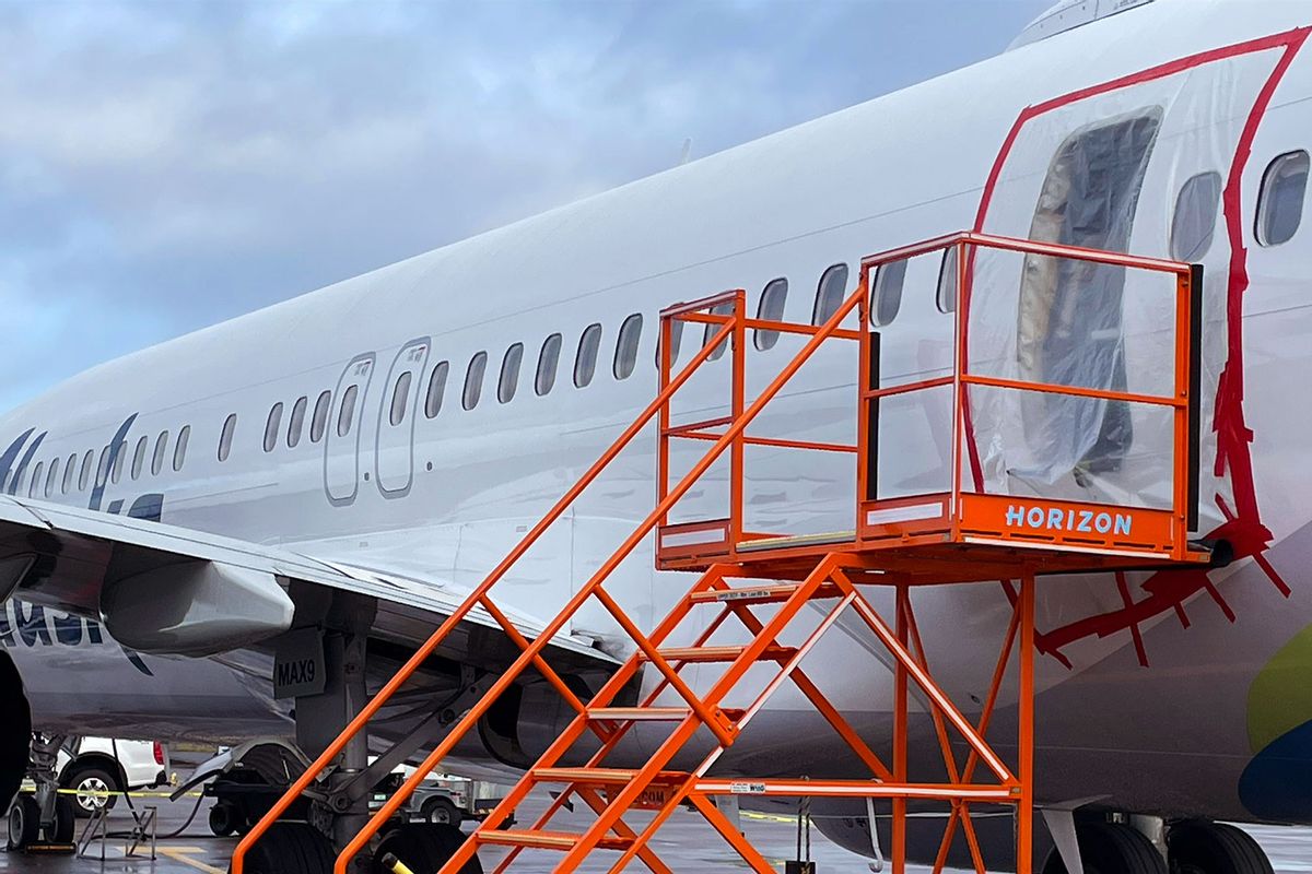 In this National Transportation Safety Board (NTSB) handout, plastic covers the exterior of the fuselage plug area of Alaska Airlines Flight 1282 Boeing 737-9 MAX on January 7, 2024 in Portland, Oregon. (NTSB via Getty Images)